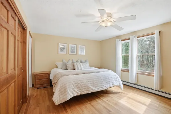 a bedroom with a large bed and a chandelier