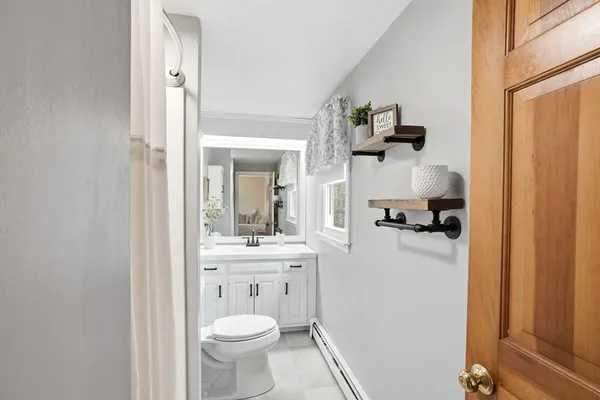 a bathroom with a toilet a sink and mirror