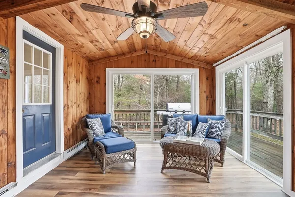 a living room with furniture and a floor to ceiling window