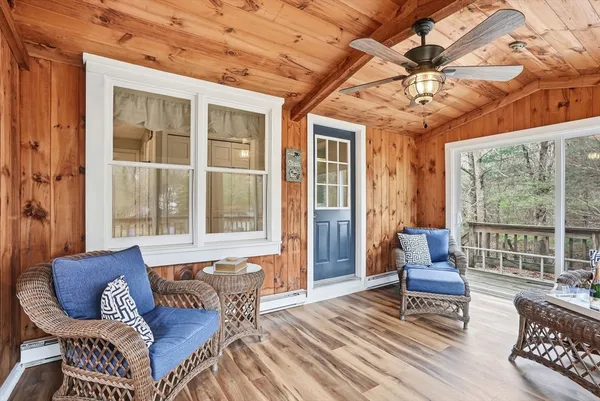 a living room with furniture and a floor to ceiling window