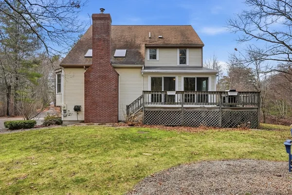 a view of house with a big yard and potted plants