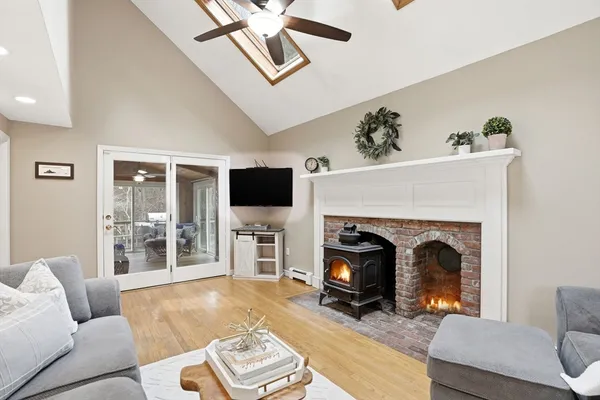 a living room with furniture a flat screen tv and a fireplace