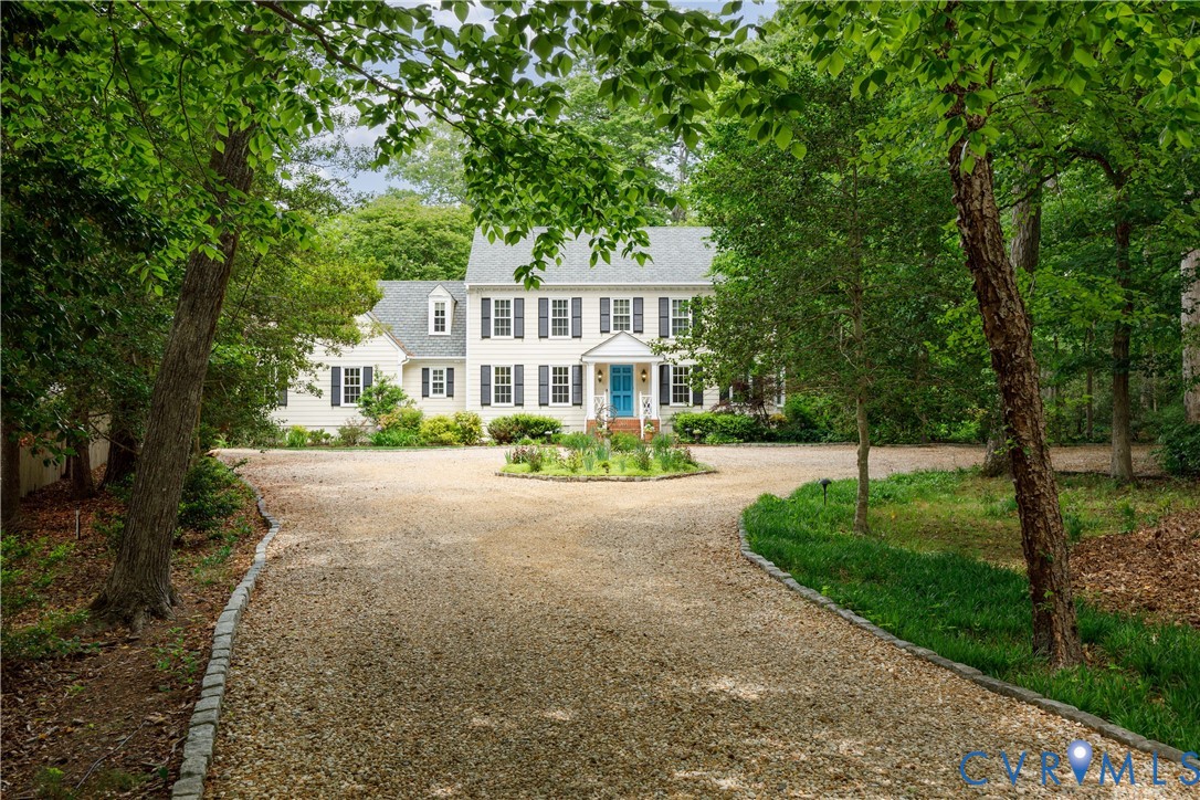 Cobblestone-lined driveway leads to the enchanting