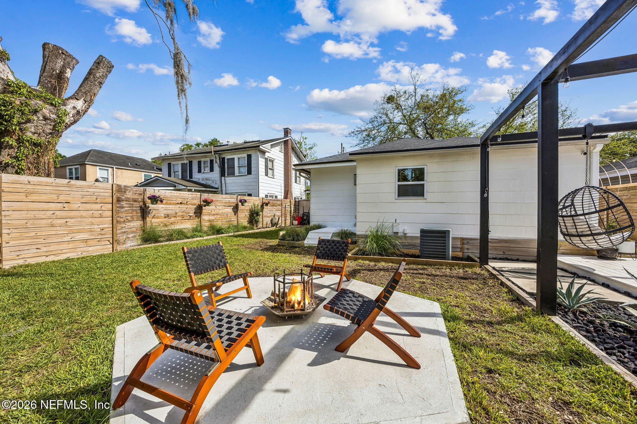 4713 French Street Jacksonville, FL 32205 - Photo 39 of 74 a view of a patio with table and chairs with wooden floor and fence