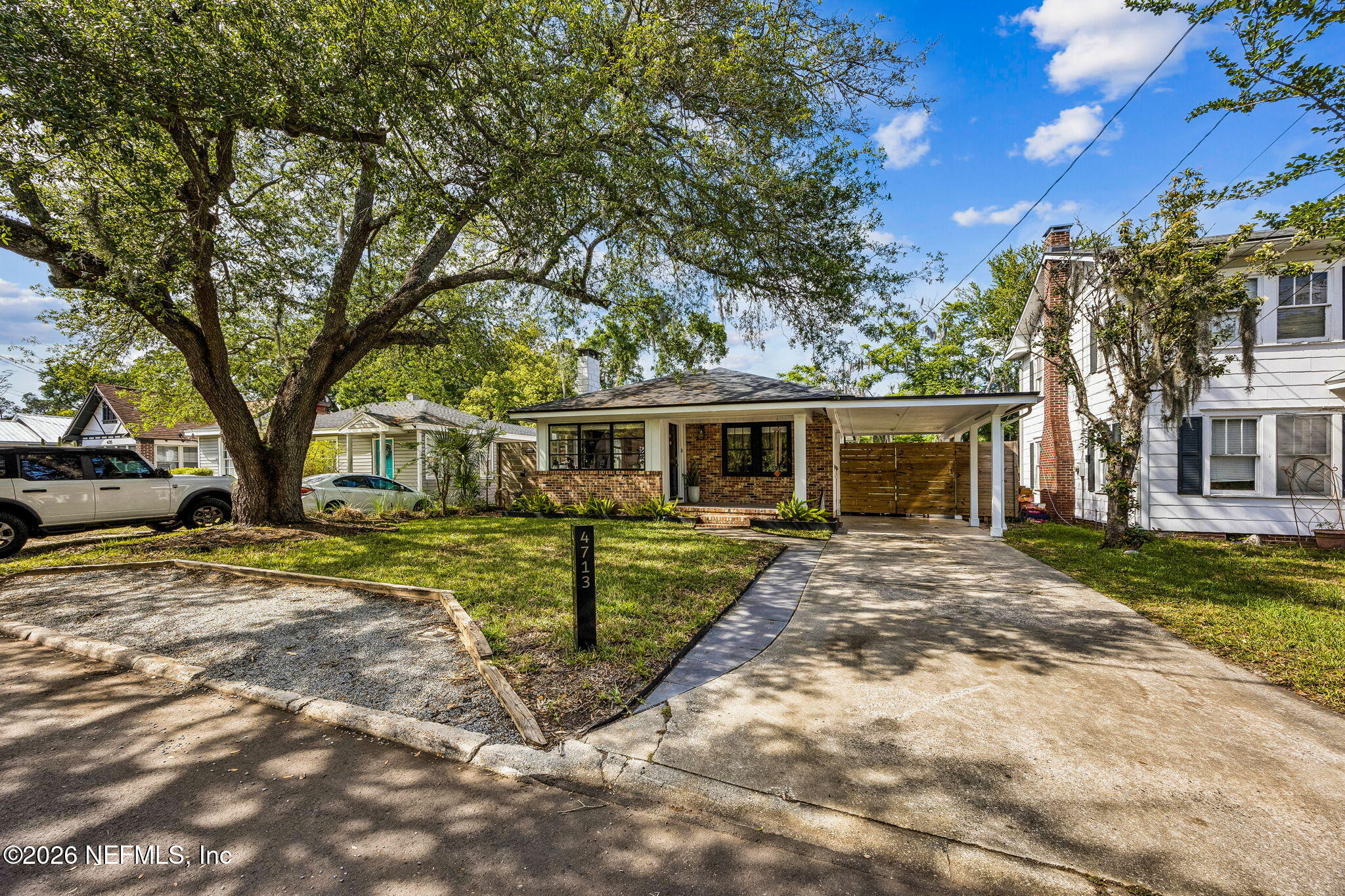 4713 French Street Jacksonville, FL 32205 - Photo 6 of 74 a view of a yard in front of a house with a large tree