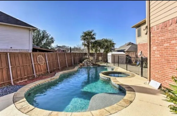 a view of a house with pool and sitting area
