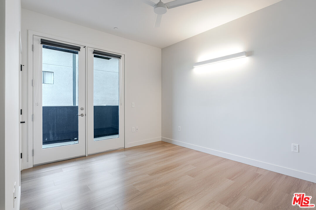 10601 Washington Boulevard, Unit 232 Culver City, CA 90232 - Photo 13 of 30 an empty room with wooden floor and windows