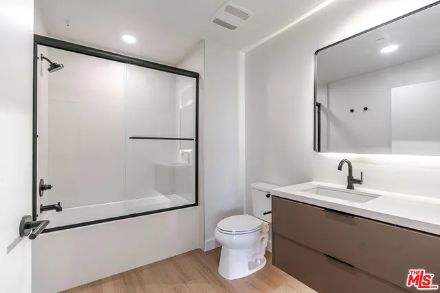 a bathroom with a toilet sink and a mirror