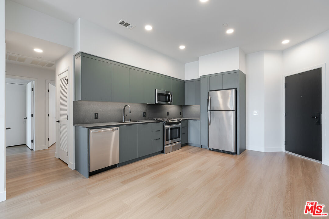 10601 Washington Boulevard, Unit 232 Culver City, CA 90232 - Photo 2 of 30 a kitchen with granite countertop a refrigerator and a sink