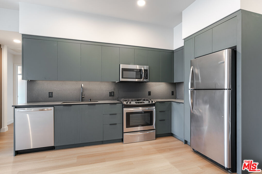 10601 Washington Boulevard, Unit 232 Culver City, CA 90232 - Photo 3 of 30 a kitchen with stainless steel appliances granite countertop a refrigerator and a stove top oven