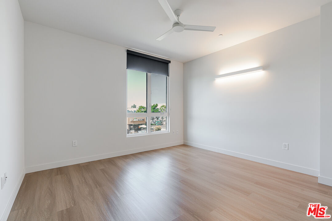 10601 Washington Boulevard, Unit 232 Culver City, CA 90232 - Photo 10 of 30 an empty room with wooden floor and windows