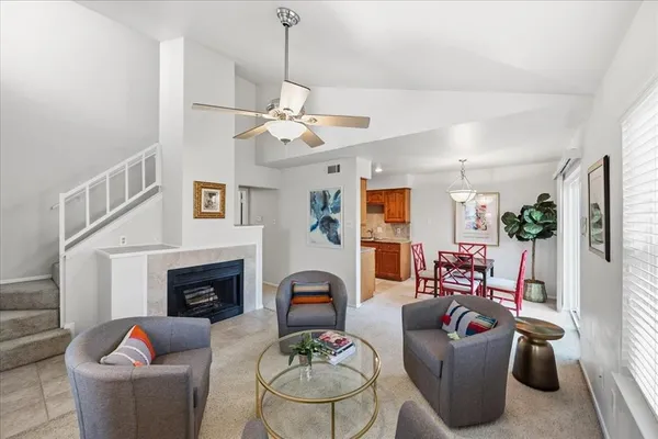 a living room with furniture a fireplace and a flat screen tv