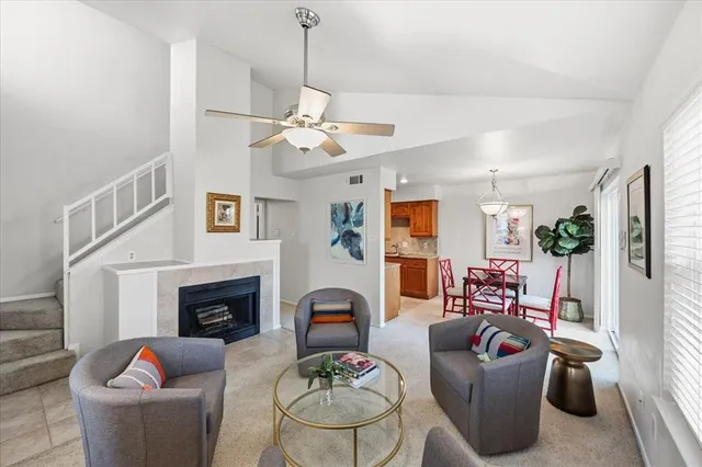 a living room with furniture a fireplace and a flat screen tv