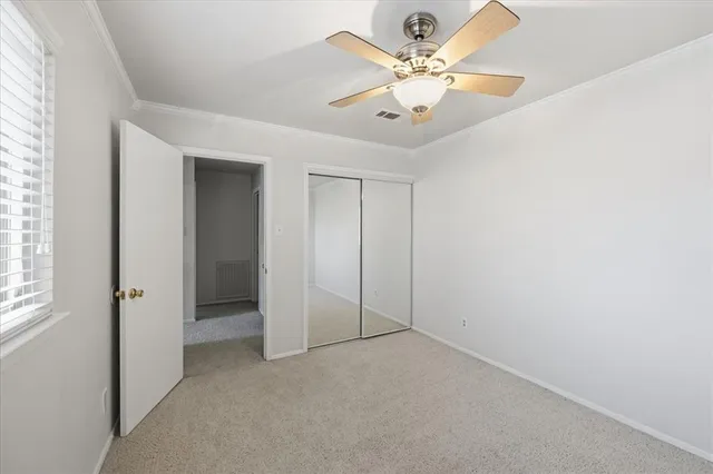 a bathroom with a granite countertop sink a toilet and a mirror