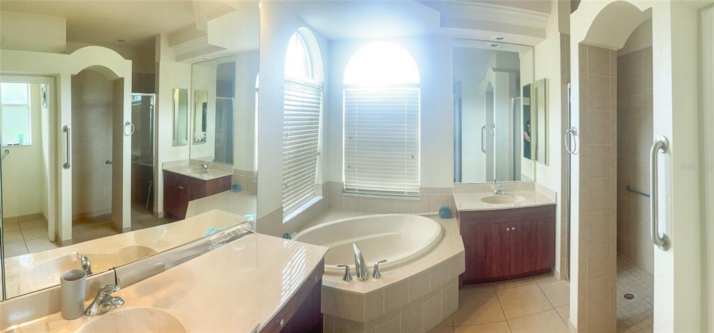 7243 Bahama Swallow Avenue Weeki Wachee, FL 34613 - Photo 13 of 18 a spacious bathroom with a tub sink and mirror