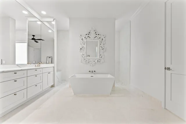 a bathroom with a granite countertop sink a toilet and a shower