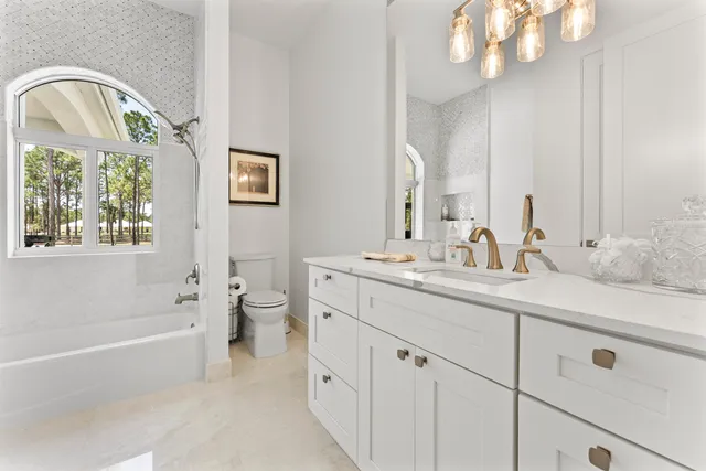a living room with furniture kitchen view and a window
