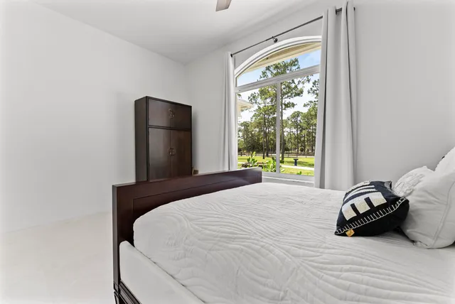 a living room with furniture a flat screen tv and a window