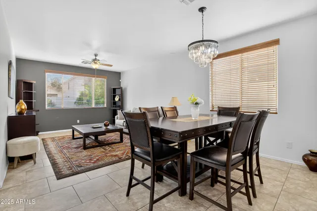 a spacious kitchen with stainless steel appliances a sink and a refrigerator
