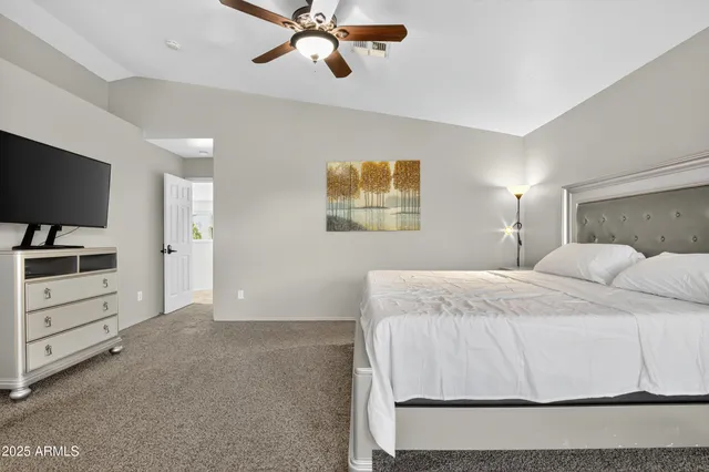 a bedroom with a bed and a flat screen tv