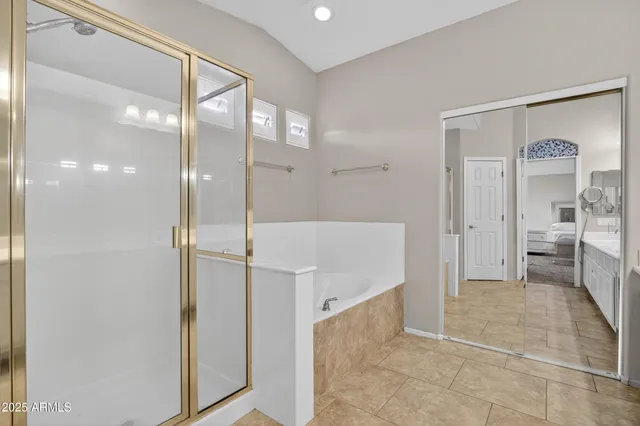 a spacious bathroom with a double vanity sink mirror and shower
