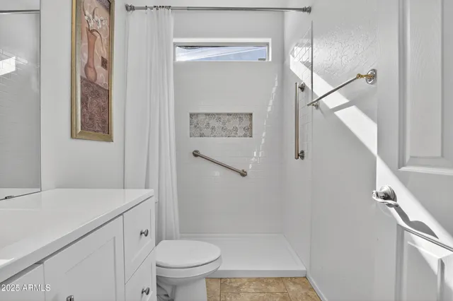 a spacious bedroom with a bed and ceiling fan