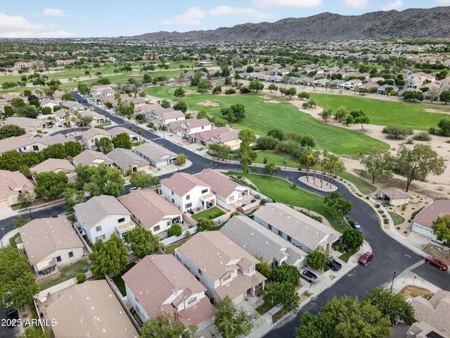 an aerial view of residential houses with outdoor space