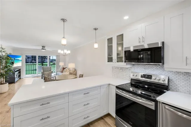 a kitchen with stainless steel appliances a stove microwave and cabinets