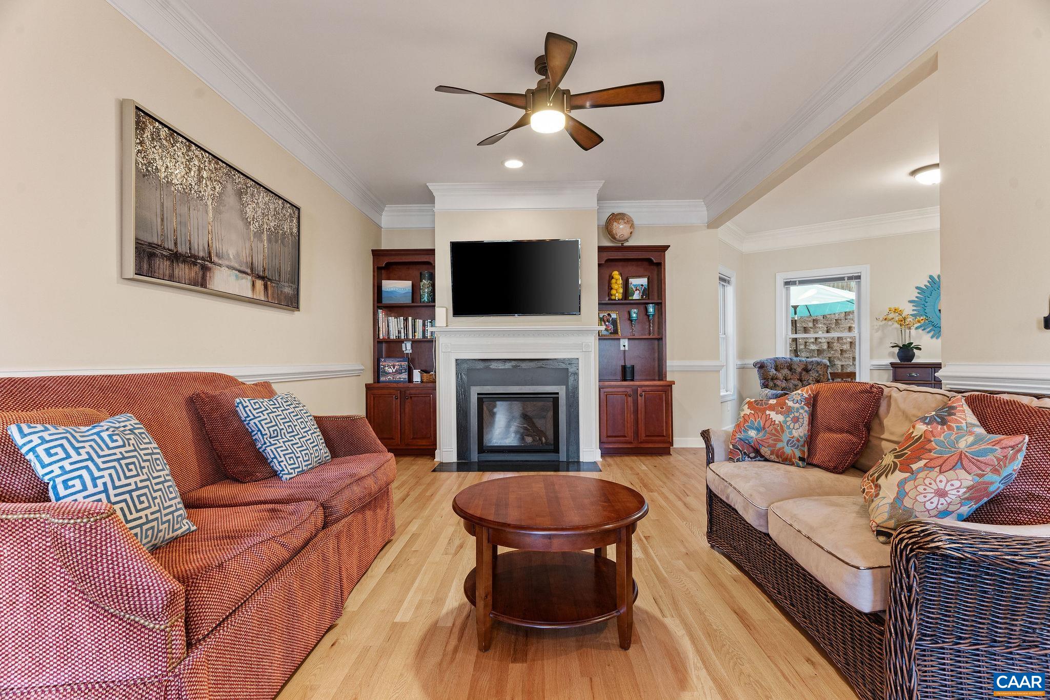 1286 Chatham Ridge Charlottesville, VA 22901 - Photo 11 of 33 a living room with furniture a flat screen tv and a fireplace