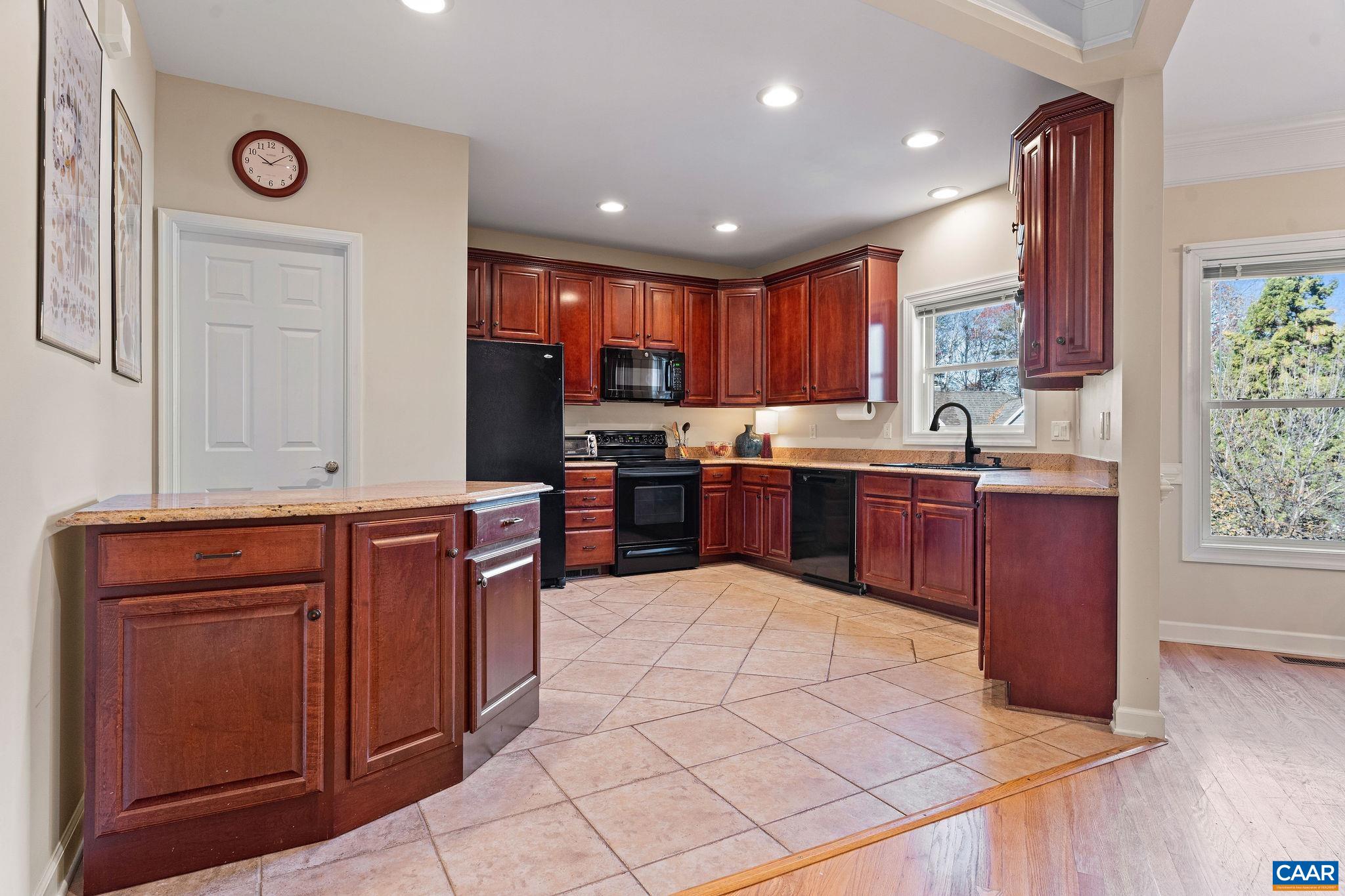 1286 Chatham Ridge Charlottesville, VA 22901 - Photo 14 of 33 a kitchen with stainless steel appliances granite countertop wooden cabinets a sink and dishwasher