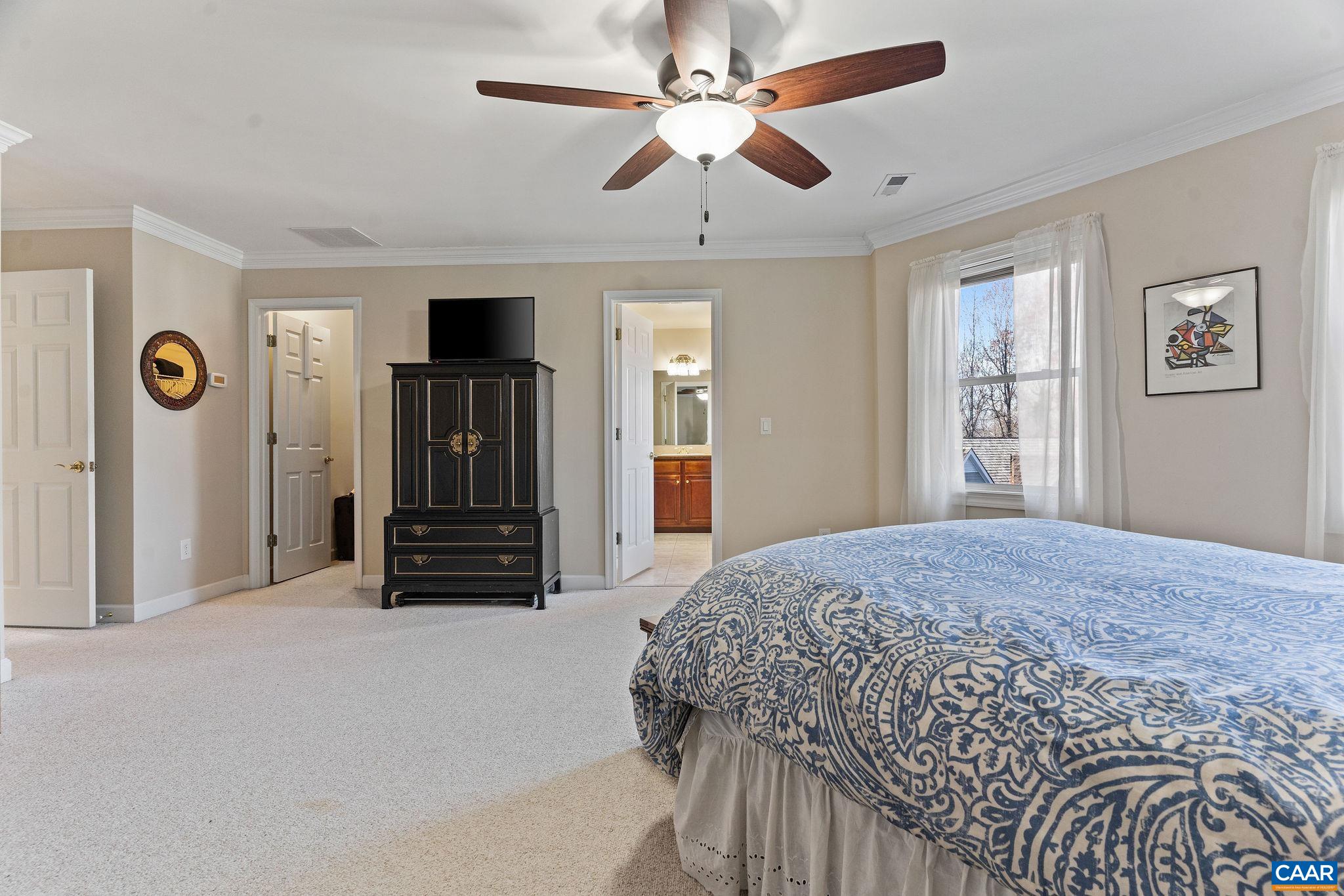 1286 Chatham Ridge Charlottesville, VA 22901 - Photo 28 of 33 a bedroom with a bed and a chandelier