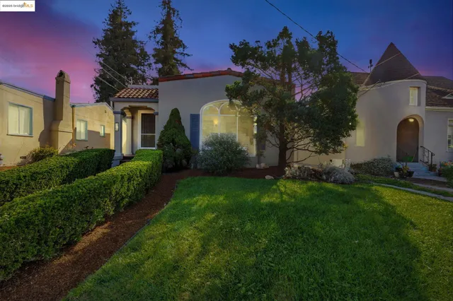 a front view of a house with a garden