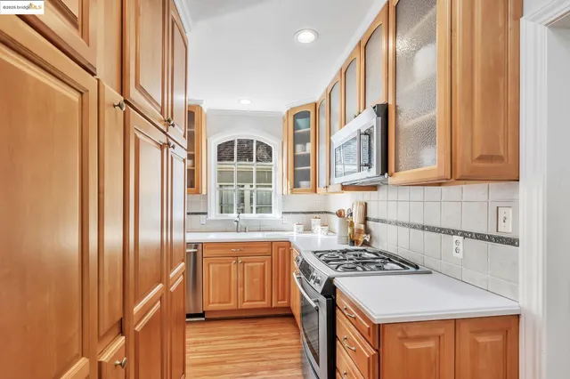 a kitchen with stainless steel appliances granite countertop a stove and a refrigerator