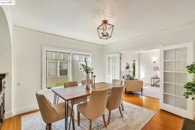 a view of a dining room with furniture wooden floor and a chandelier