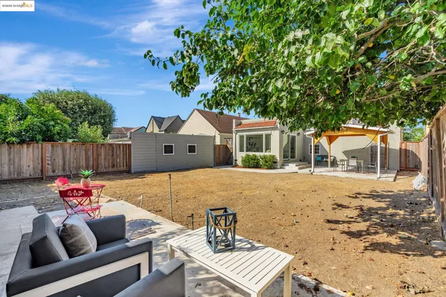 a view of backyard with swimming pool and seating