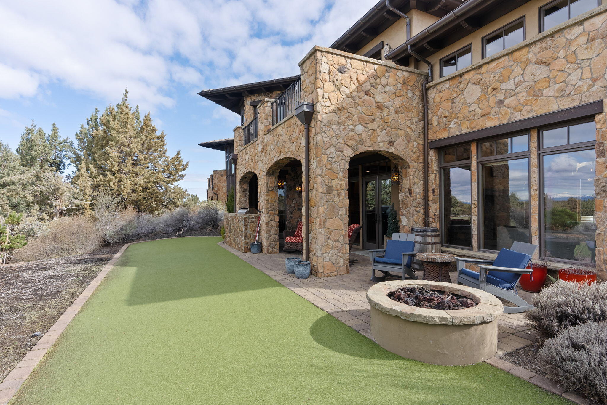 22887 Ghost Tree Lane Bend, OR 97701 - Photo 33 of 97 Enjoy the mountian views from the rear paver patio complete with gas firepit, outdoor kitchen and putting green/bocceball court.