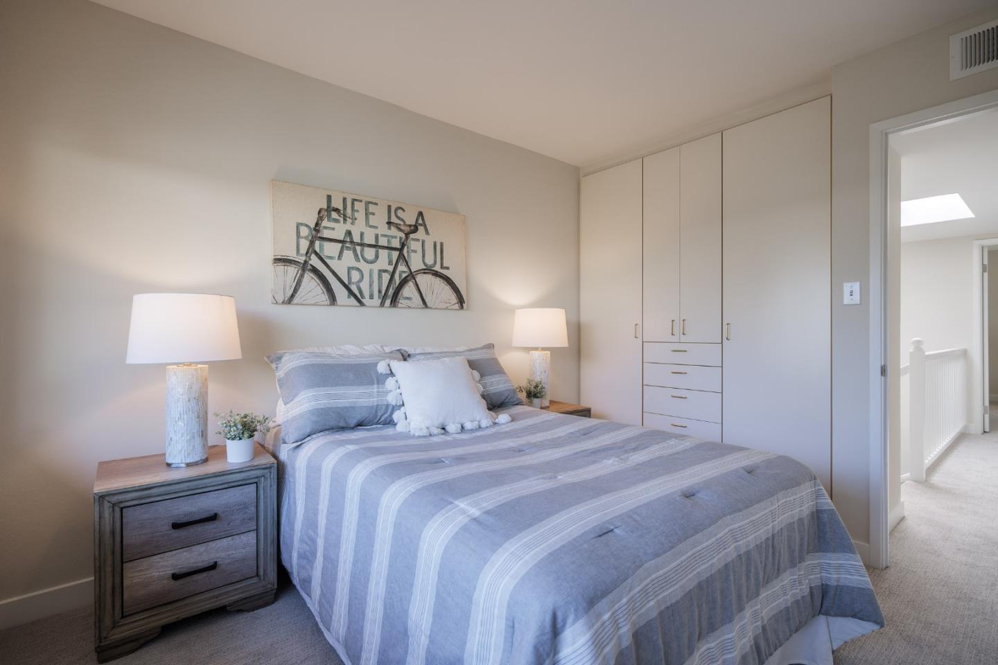 2313 Sharon Road Menlo Park, CA 94025 - Photo 13 of 29 a bedroom with a bed and a lamp on dresser