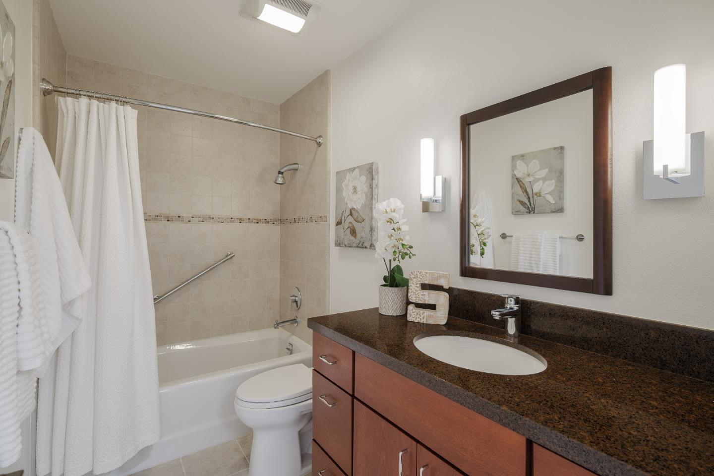 2313 Sharon Road Menlo Park, CA 94025 - Photo 16 of 29 a bathroom with a granite countertop sink toilet and shower