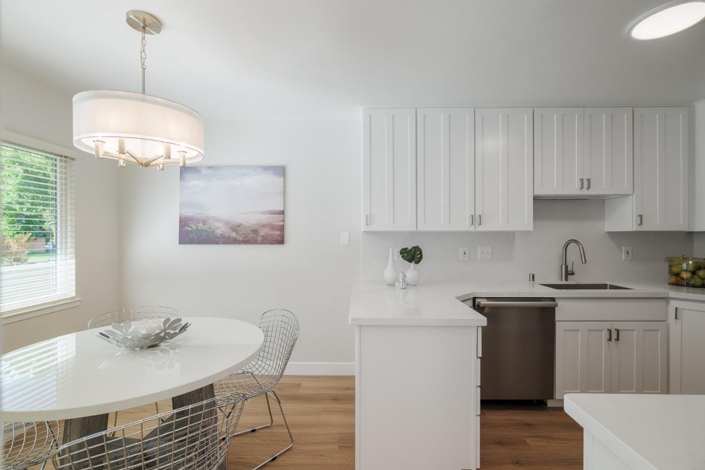2313 Sharon Road Menlo Park, CA 94025 - Photo 4 of 29 a kitchen with stainless steel appliances granite countertop a sink a stove a dining table and chairs with wooden floor