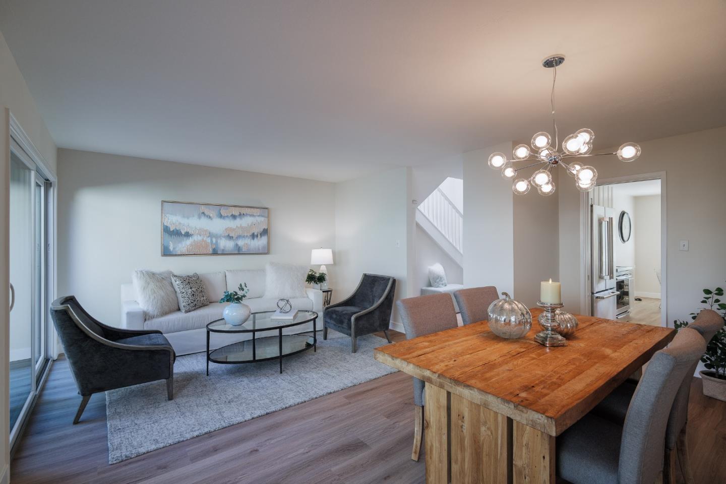 2313 Sharon Road Menlo Park, CA 94025 - Photo 6 of 29 a living room with furniture a lamp a chandelier and wooden floor
