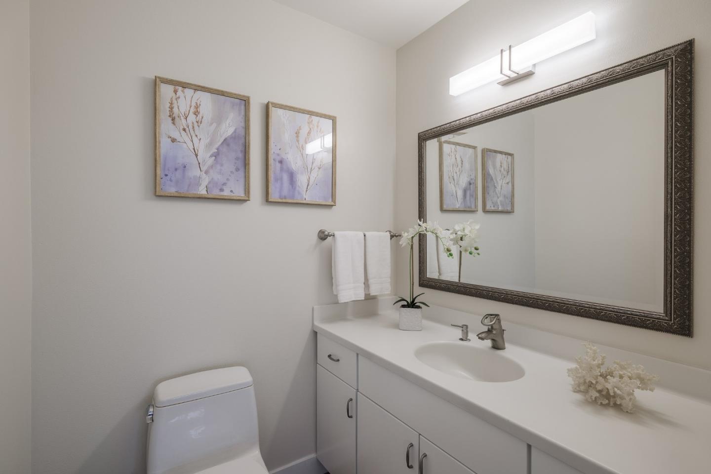 2313 Sharon Road Menlo Park, CA 94025 - Photo 10 of 29 a bathroom with a toilet sink and mirror