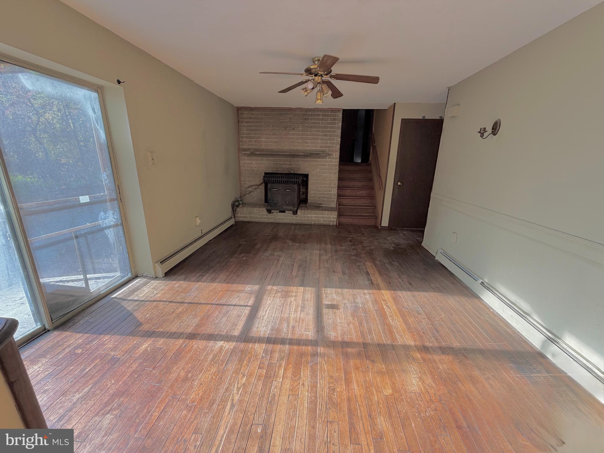 318 Marienstein Road Upper Black Eddy, PA 18972 - Photo 4 of 14 a view of empty room with wooden floor and fireplace