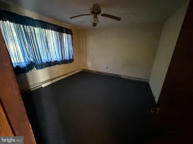wooden floor in an empty room and a window