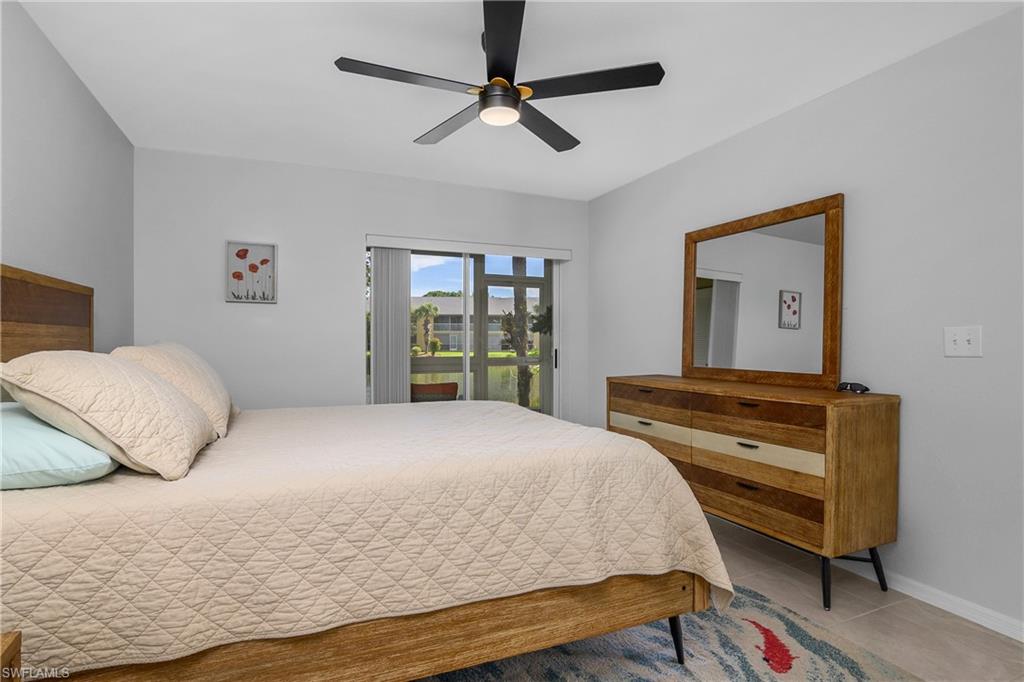 1330 Yesica Ann Circle, Unit I106 Naples, FL 34110 - Photo 15 of 38 a bedroom with a bed and a dresser