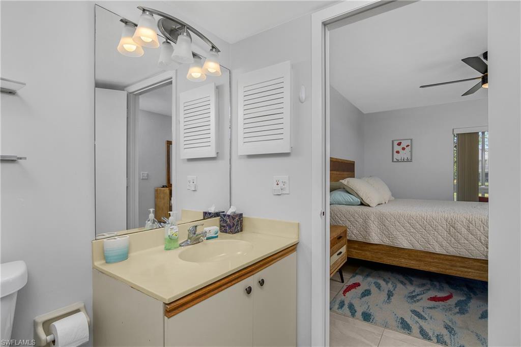 1330 Yesica Ann Circle, Unit I106 Naples, FL 34110 - Photo 17 of 38 a en suite bathroom with a sink and a mirror
