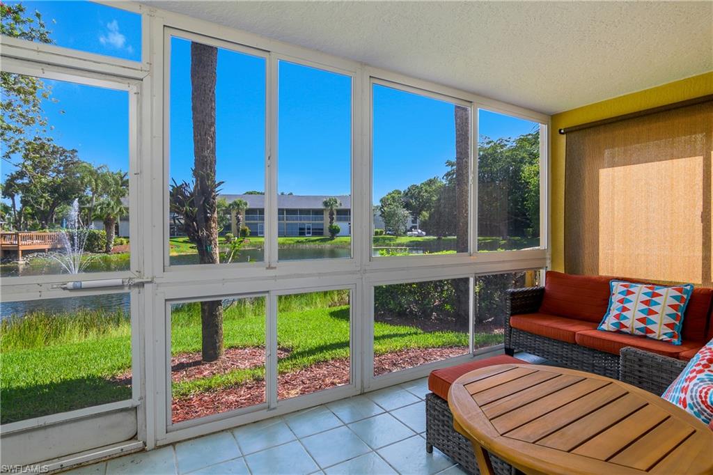 1330 Yesica Ann Circle, Unit I106 Naples, FL 34110 - Photo 27 of 38 a view of a patio with a table chairs and a swimming pool