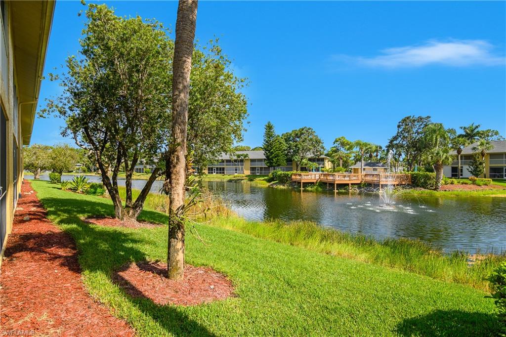 1330 Yesica Ann Circle, Unit I106 Naples, FL 34110 - Photo 29 of 38 a view of a lake with a yard
