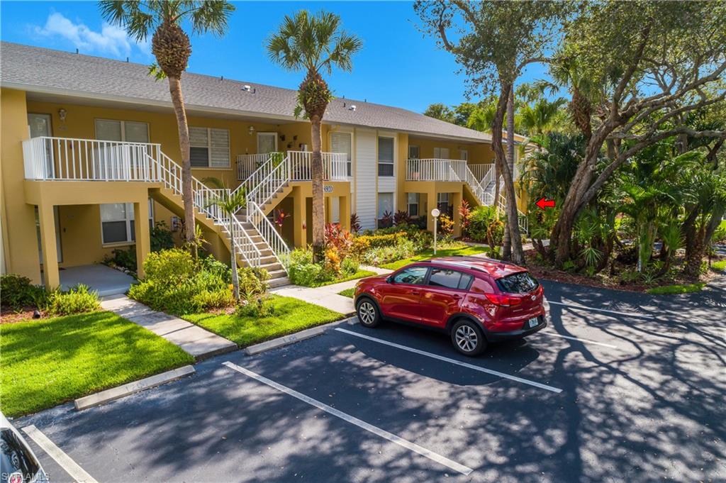 1330 Yesica Ann Circle, Unit I106 Naples, FL 34110 - Photo 30 of 38 a front view of a house with garden