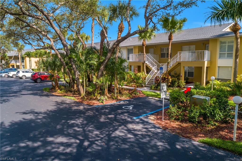 1330 Yesica Ann Circle, Unit I106 Naples, FL 34110 - Photo 32 of 38 a view of a house with a yard and tree s