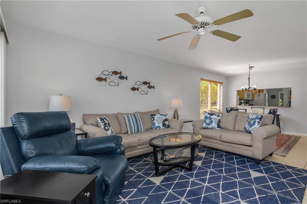 1330 Yesica Ann Circle, Unit I106 Naples, FL 34110 - Photo 5 of 38 a living room with furniture a chandelier and a window